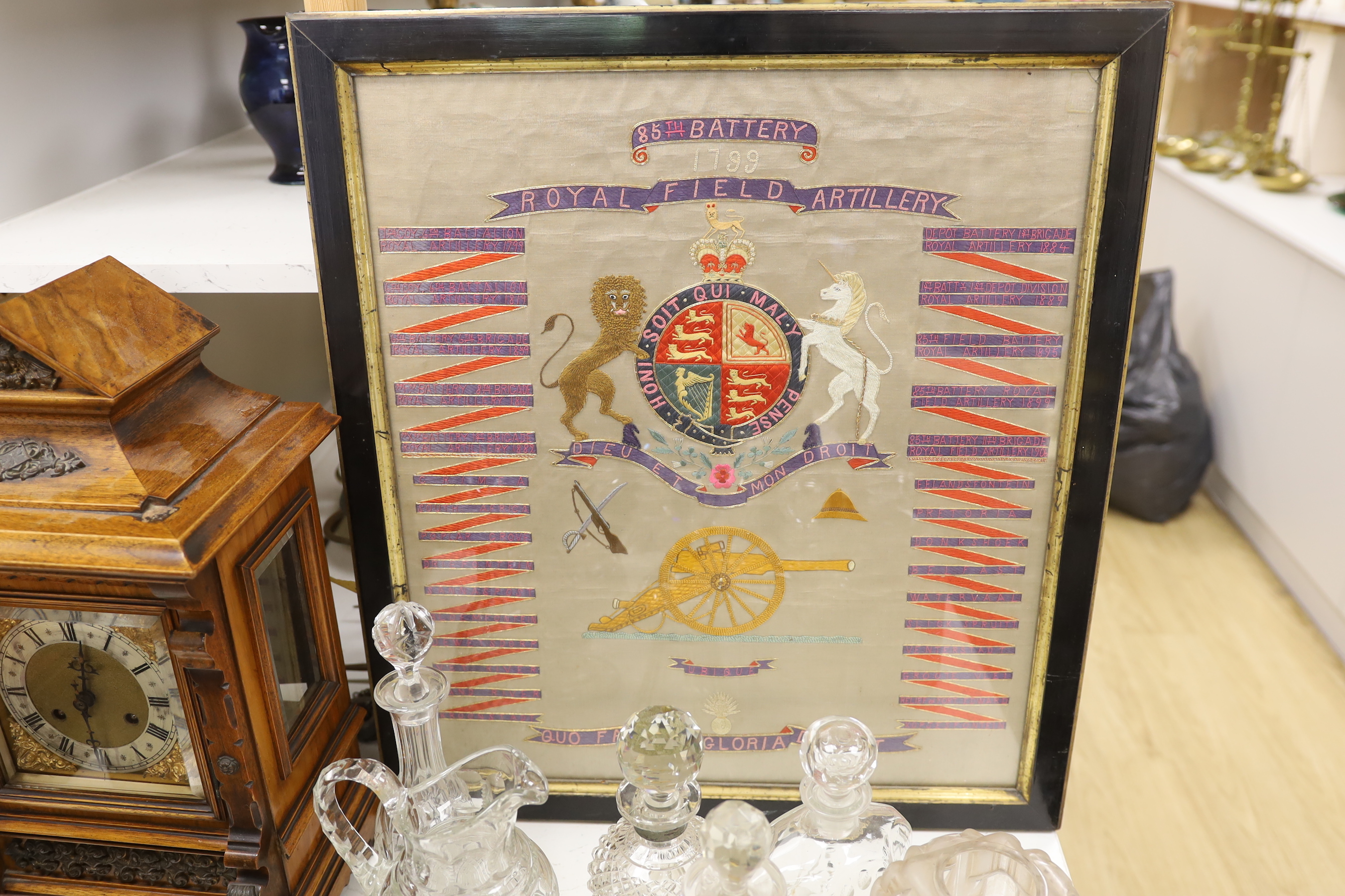 A framed Royal Field Artillery crest and six WWI postcards, framed